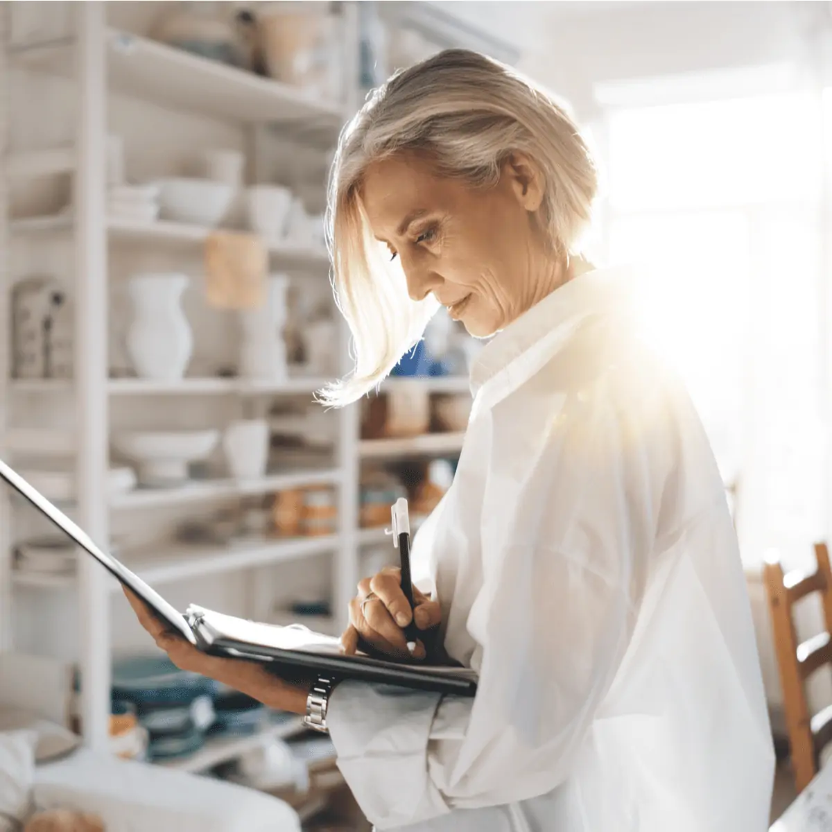 Senior woman making notes in a folder