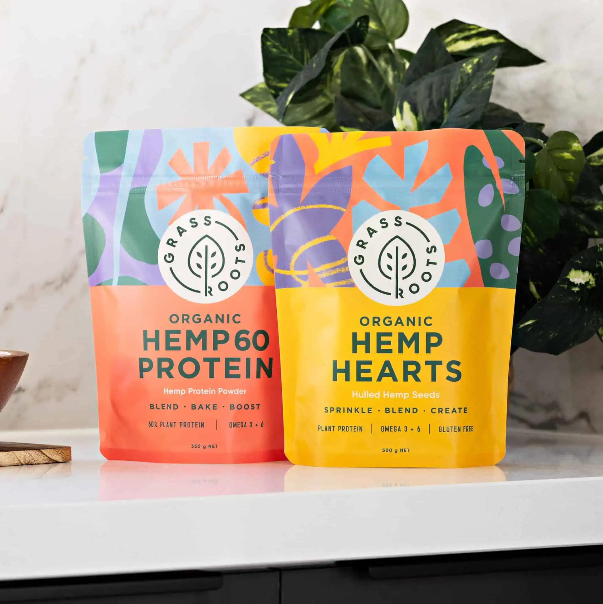 Hemp hearts in flexible packaging on a table beside a green plant, showcasing a natural and healthy lifestyle.